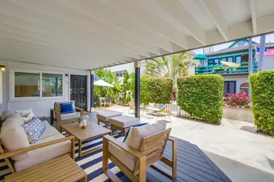 an outdoor patio with couches and tables and chairs at Avalon Beach 1 in San Diego
