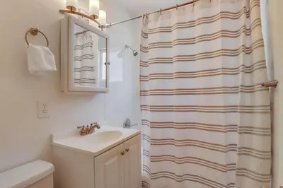 a bathroom with a sink and a shower curtain at Avalon Beach 1 in San Diego