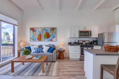 a kitchen and living room with a couch and a table at Jetty View 2 in San Diego