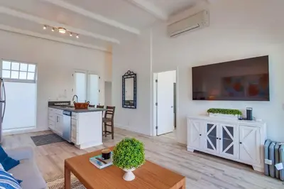 a living room with a kitchen and a table at Jetty View 2 in San Diego