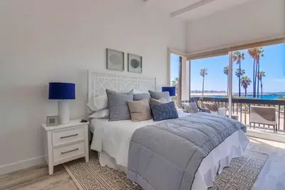 a bedroom with a bed with a view of the ocean at Jetty View 2 in San Diego