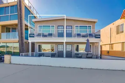 a large house with a balcony with tables and chairs at Bayside 4 in San Diego