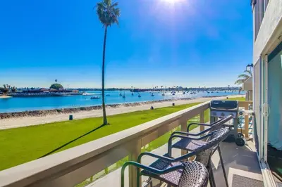two chairs on a balcony looking at the beach at Bay Style 2 in San Diego