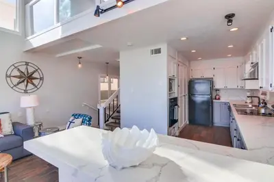 a kitchen and living room with a white counter top at Bay Style 2 in San Diego