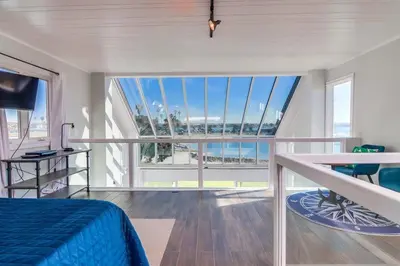 a bedroom with a bed and a large window at Bay Style 2 in San Diego