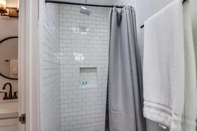 a bathroom with a shower with a shower curtain at Bay Style 2 in San Diego