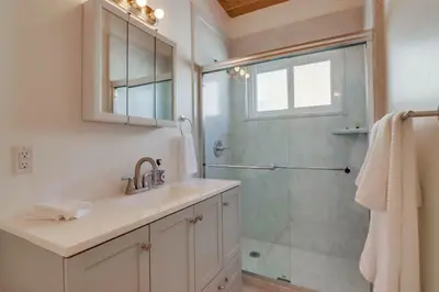 a bathroom with a sink and a glass shower at Bayside 5 in San Diego