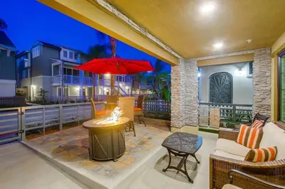 a patio with a table with a red umbrella at Bayside Cove 1 in San Diego