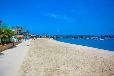 a sandy beach next to a body of water at Bayside Cove 1 in San Diego