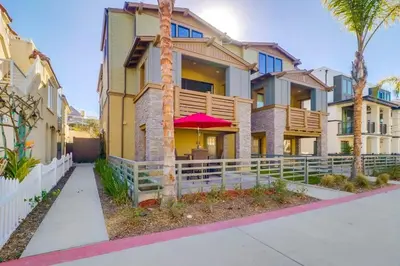 a house with palm trees in front of it at Bayside Cove 1 in San Diego