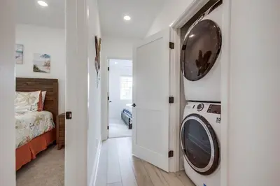 a bedroom with a washer and dryer in a room at Bayside Cove 1 in San Diego