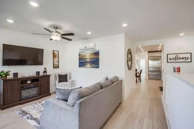 a living room with a couch and a flat screen tv at Bayside Cove 1 in San Diego