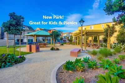 a park with benches and trees and a building at Bayside Cove 3 in San Diego