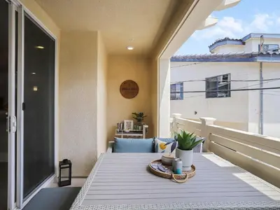 a table on a balcony with a view of a building at Bayside Cove 3 in San Diego