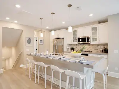 a kitchen with a large island with white cabinets at Bayside Cove 3 in San Diego