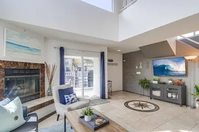 a living room with a fireplace and a tv at Beach Haven 2 in San Diego