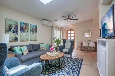 a living room with a blue couch and a table at Beach & Bay in San Diego