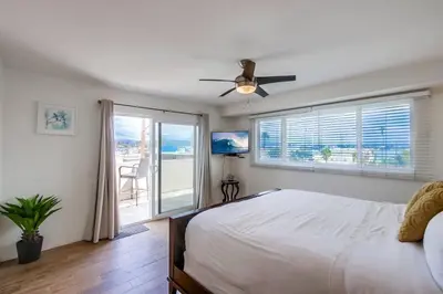 a bedroom with a bed and a ceiling fan at Beach Break 1 in San Diego