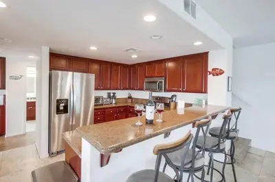 a kitchen with a counter with wine glasses on it at Beach Break 1 in San Diego