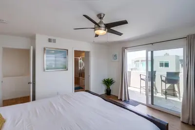 a bedroom with a bed and a ceiling fan at Beach Break 1 in San Diego