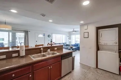 a large kitchen with a sink and a living room at Beach Break 1 in San Diego