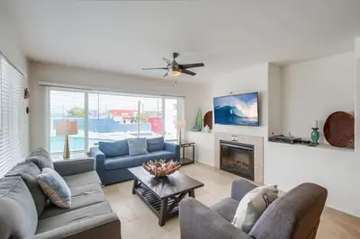 a living room with two couches and a fireplace at Beach Break 1 in San Diego