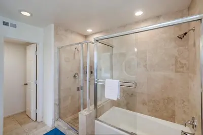 a bathroom with a shower with a glass door at Beach Break 1 in San Diego