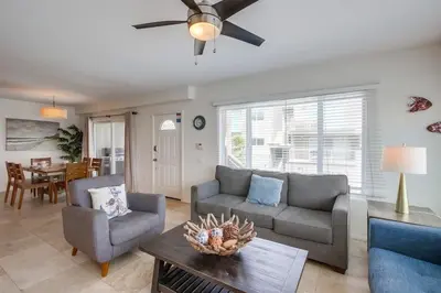 a living room with two couches and a ceiling fan at Beach Break 1 in San Diego