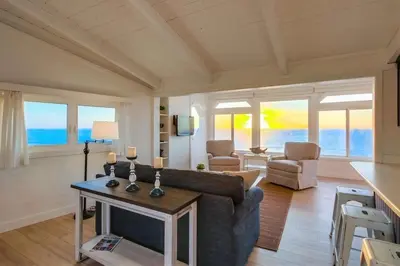 a living room with a couch and a table at Beacons in Encinitas
