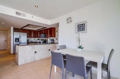 a kitchen and dining room with a white table and chairs at Belmont Shores in San Diego