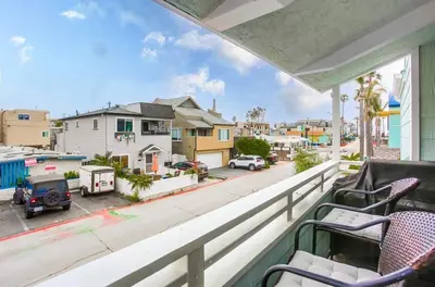 a balcony with chairs and a view of a street at Beach Style 1 in San Diego