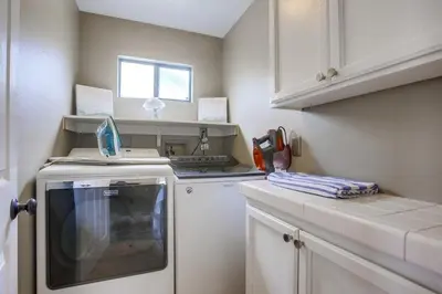 a small kitchen with a stove and a dishwasher at Beach Style 1 in San Diego