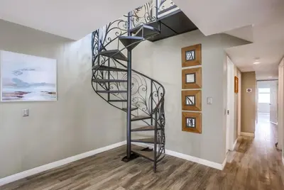 a spiral staircase in a room with a hallway at Beach Style 1 in San Diego