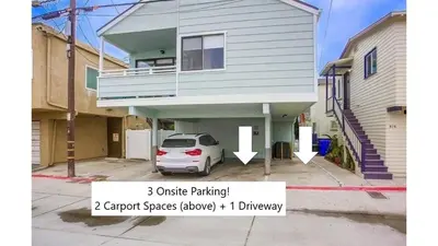 a house with a car parked in a driveway at Beach Style 1 in San Diego