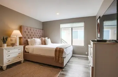 a bedroom with a large bed and a window at Beach Style 1 in San Diego