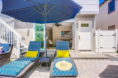 a pair of chairs and an umbrella on a patio at Brighton Beach in San Diego