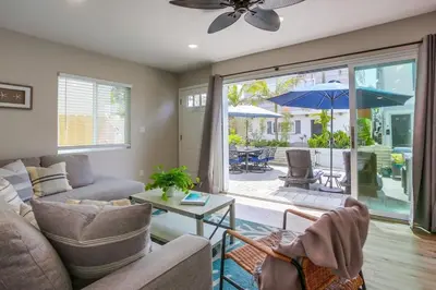 a living room with a couch and a table with an umbrella at Brighton Beach in San Diego