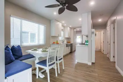 a kitchen and dining room with a table and a ceiling fan at Brighton Beach in San Diego
