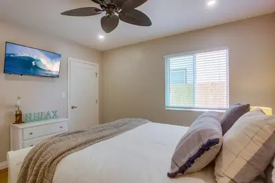 a bedroom with a bed and a ceiling fan at Brighton Beach in San Diego