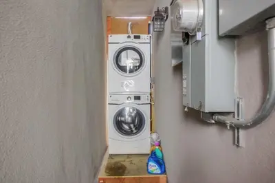 two washing machines are in a room with a wall at Brighton Beach in San Diego