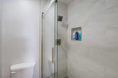 a bathroom with a glass shower with a toilet at Local Gem 2 in San Diego