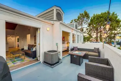 a patio with a couch and a fireplace on a house at Local Gem 4 in San Diego