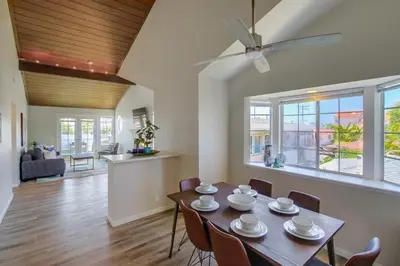 a dining room and living room with a table and chairs at Local Gem 4 in San Diego
