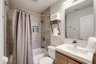a bathroom with a sink and a toilet and a mirror at Local Gem 4 in San Diego