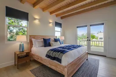 a bedroom with a large bed and a large window at Ocean Oasis in Encinitas