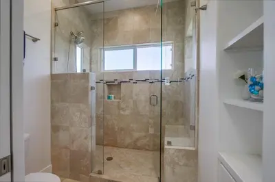 a shower with a glass door in a bathroom at Ocean Oasis in Encinitas