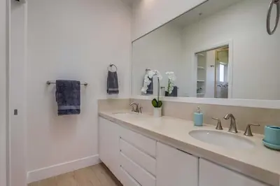 a bathroom with two sinks and a large mirror at Ocean Oasis in Encinitas