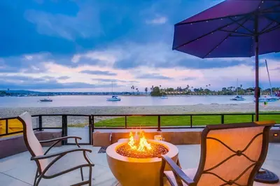 a fire pit on a deck with a view of the water at Boardwalk 6 in San Diego