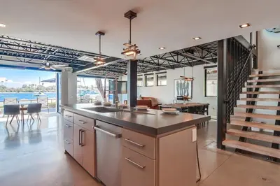an open kitchen with a staircase and a living room at Boardwalk 6 in San Diego