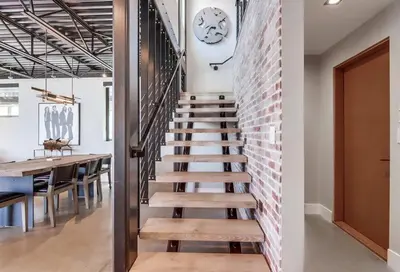 a staircase in a loft with a brick wall at Boardwalk 6 in San Diego